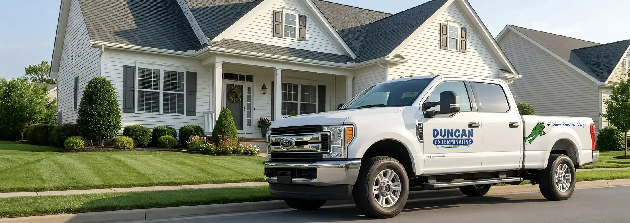 Duncan Exterminating Truck parked on road in front of a house